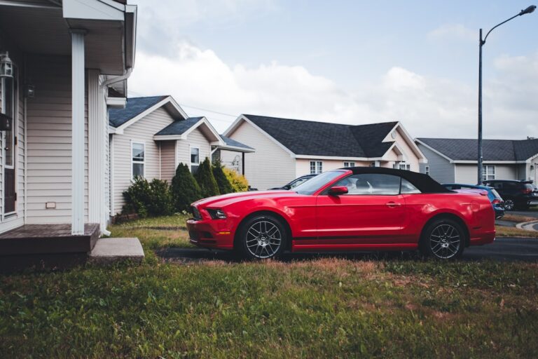 a red sports car parked in front of a house
