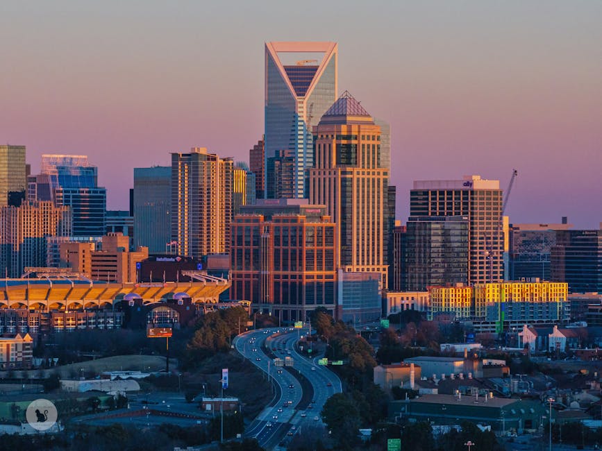 A stunning view of Charlotte's modern skyline at sunset, highlighting skyscrapers and urban design.