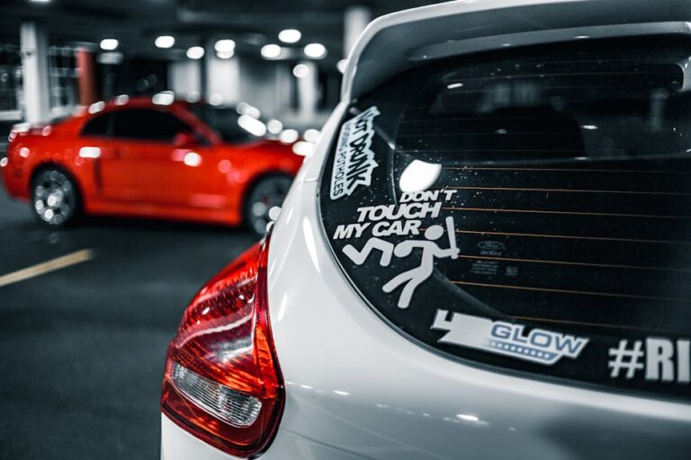 Shiny automobiles with glossy surface and taillights on parking area with glowing lights