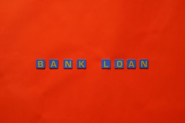 Letters forming 'Bank Loan' on a vibrant red surface, ideal for finance themes.