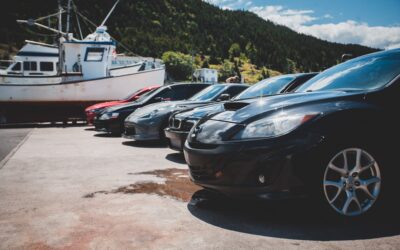 a group of cars parked next to a boat