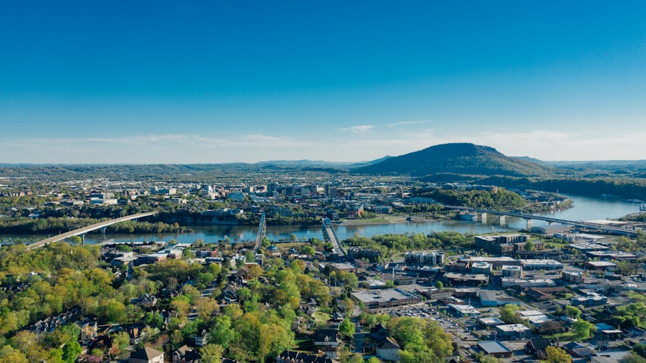 A stunning aerial view of Chattanooga, TN with the Tennessee River and scenic mountains.