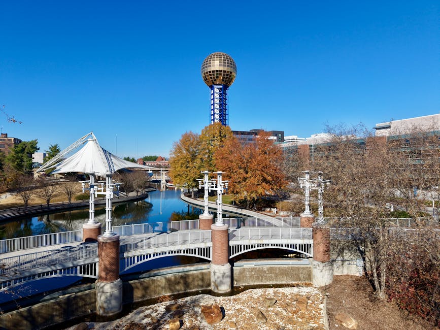 A vibrant aerial view of the iconic Sunsphere amidst fall foliage in Knoxville, Tennessee.
