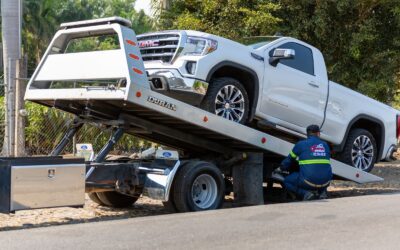 Pickup truck being loaded onto a flatbed tow truck