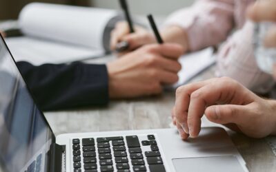Comparing options on a laptop with notes