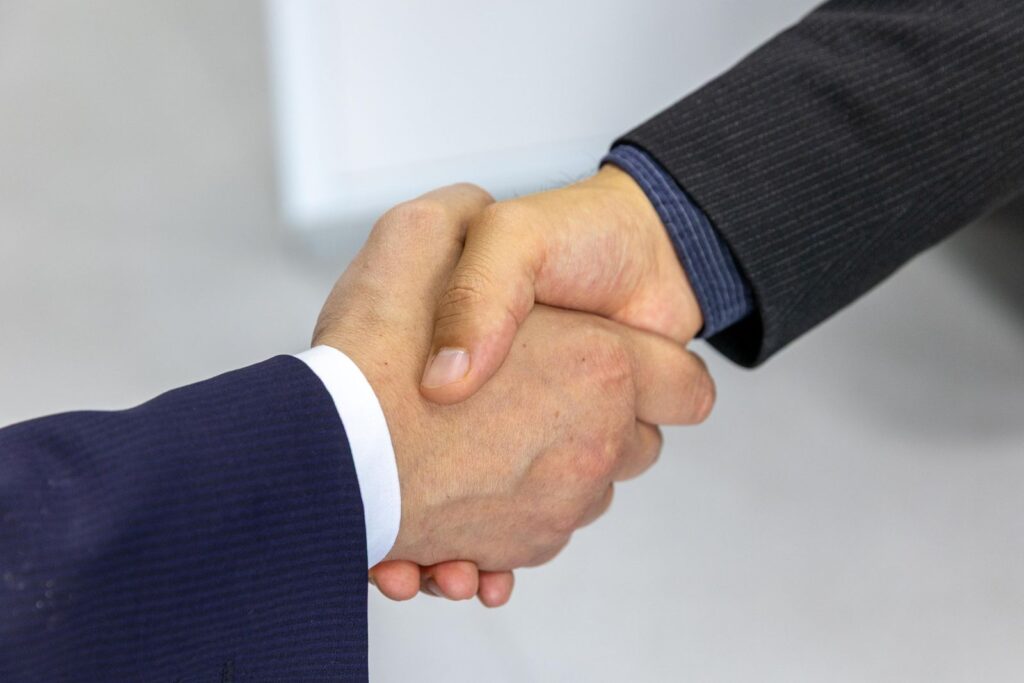 Handshake across an office desk