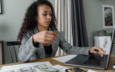 Woman managing bills and payments on a laptop at home