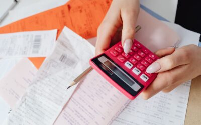 Person adding up receipts on a calculator